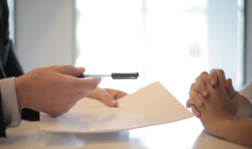 Two people reviewing and discussing a document together.